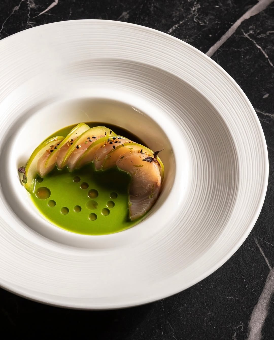 Fine dining plating from Marco's Michelin kitchen background